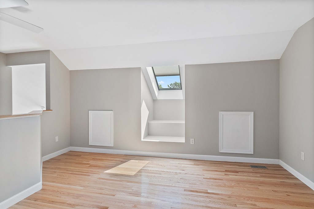 3 Strawberry Lane, Unit A Hudson, MA 01749 - Photo 23 of 29 a view of an empty room with wooden floor and a window