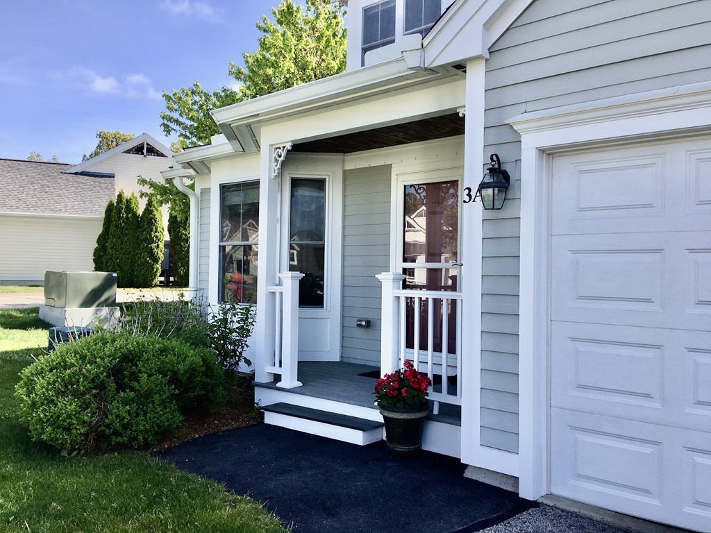 3 Strawberry Lane, Unit A Hudson, MA 01749 - Photo 3 of 29 front view of a house with a yard