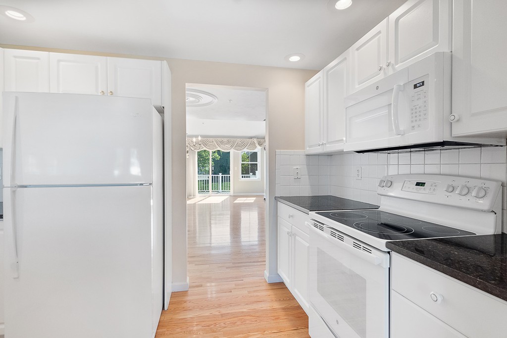 3 Strawberry Lane, Unit A Hudson, MA 01749 - Photo 10 of 29 a kitchen with cabinets and a refrigerator