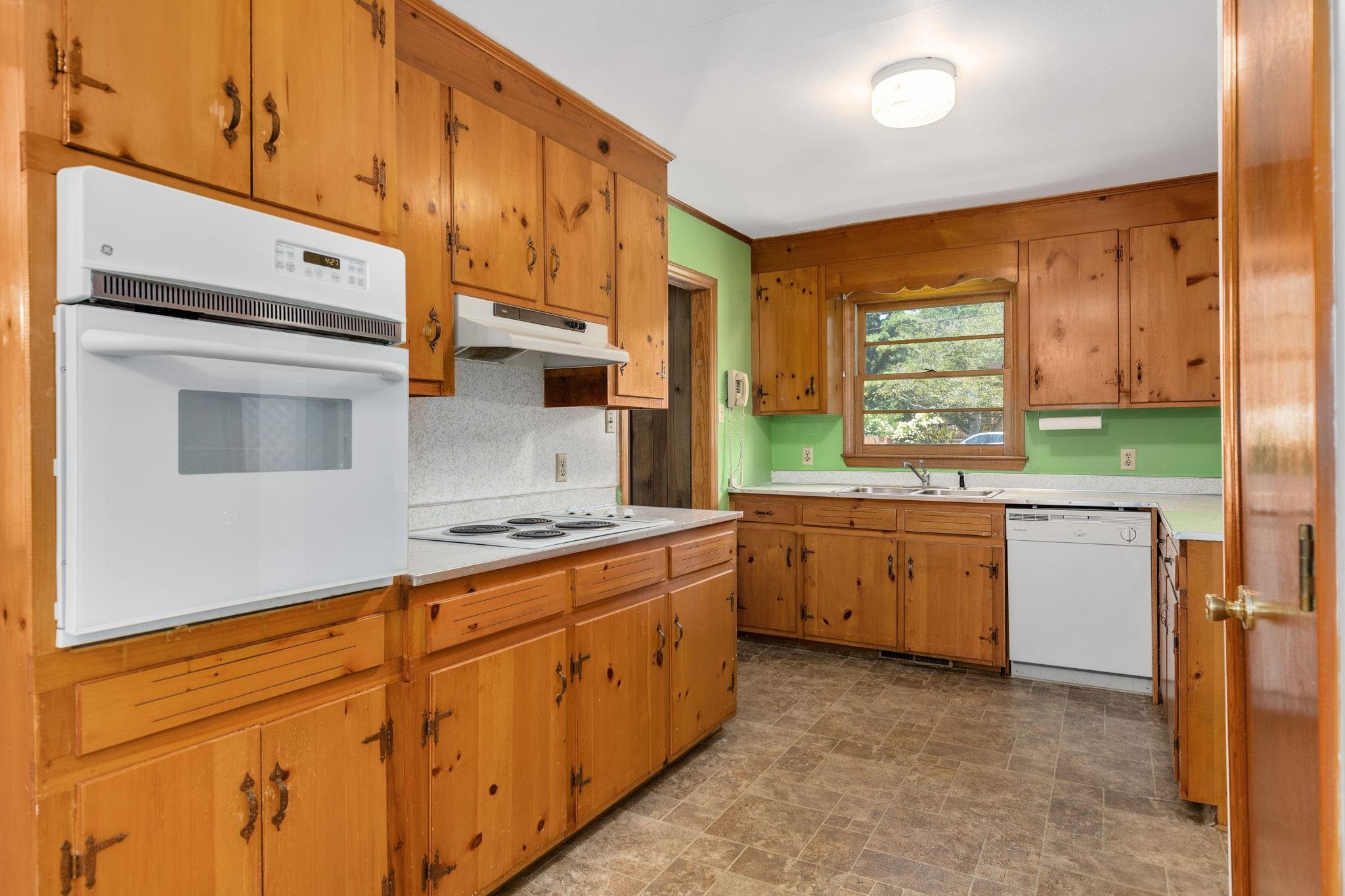 1309 Alpha Road Henderson, NC 27536 - Photo 14 of 26 a kitchen with granite countertop a stove a sink and a refrigerator