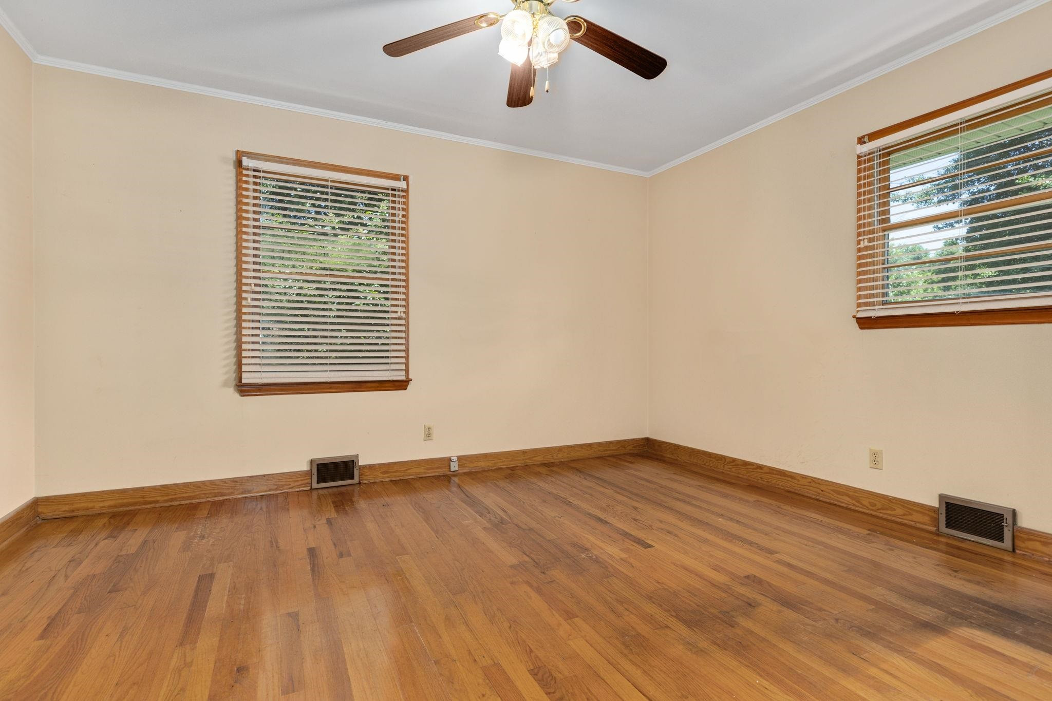 1309 Alpha Road Henderson, NC 27536 - Photo 17 of 26 a view of an empty room with wooden floor and a window