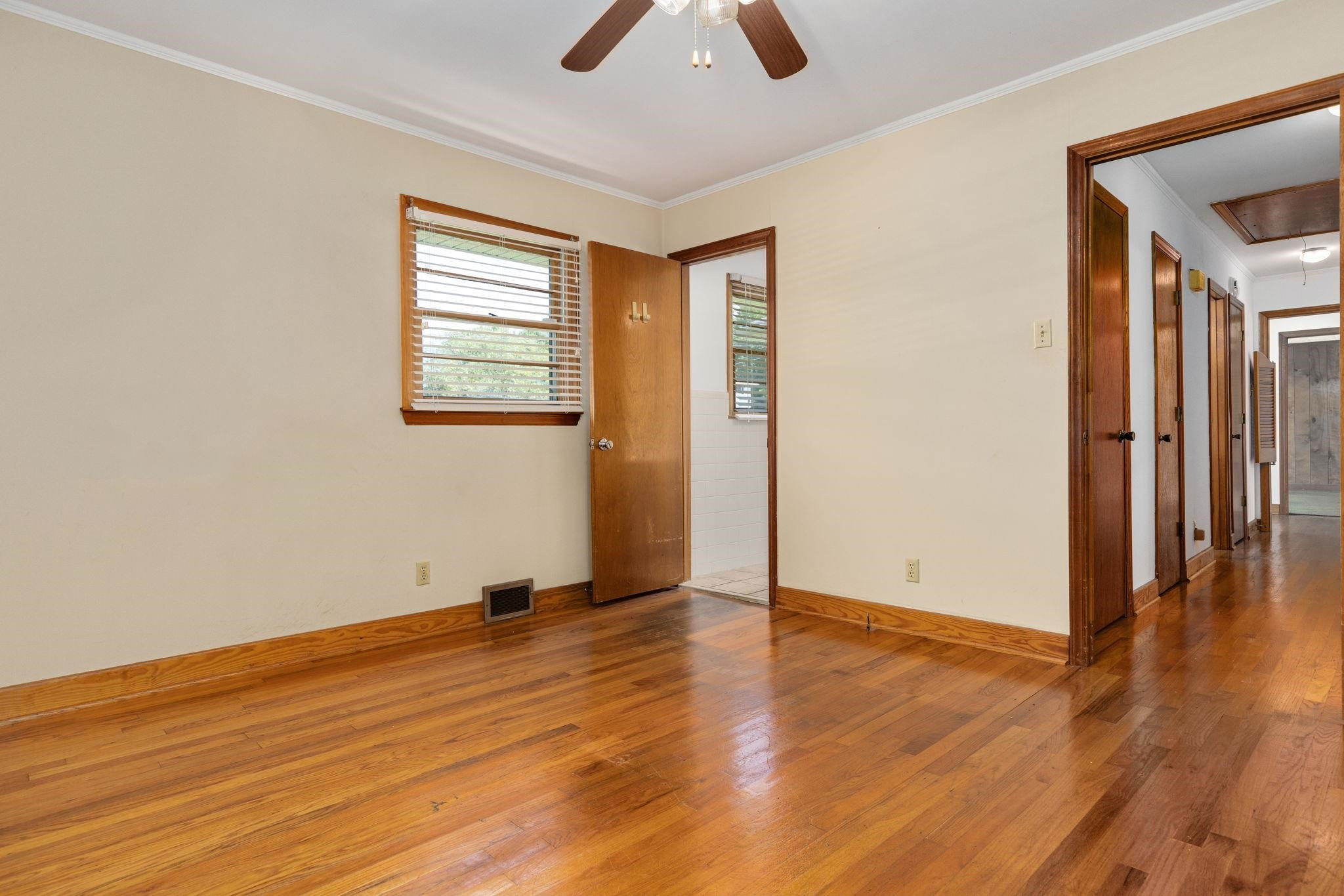 1309 Alpha Road Henderson, NC 27536 - Photo 18 of 26 an empty room with wooden floor and windows