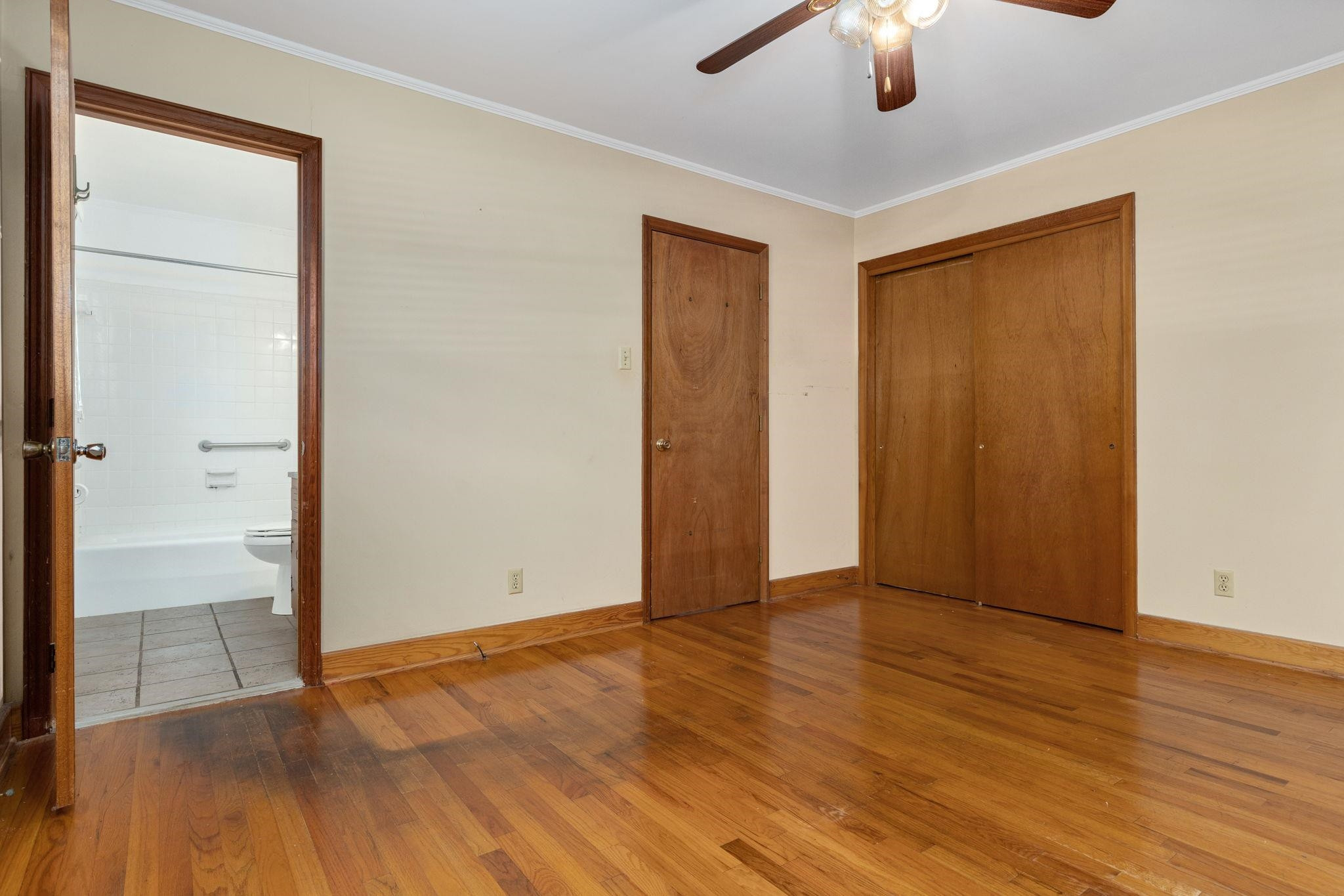 1309 Alpha Road Henderson, NC 27536 - Photo 19 of 26 an empty room with wooden floor cabinet and windows