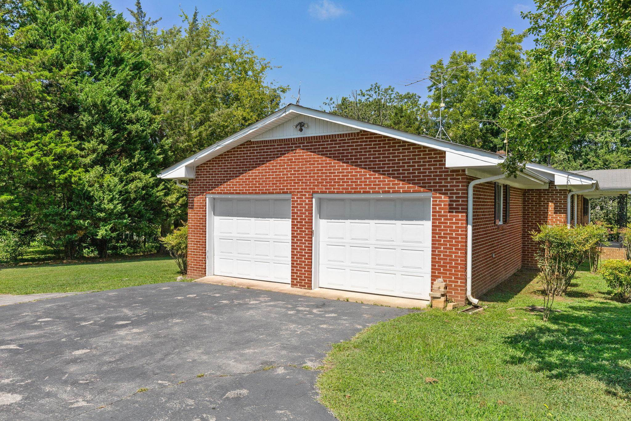 1309 Alpha Road Henderson, NC 27536 - Photo 2 of 26 a front view of a house with a yard and garage