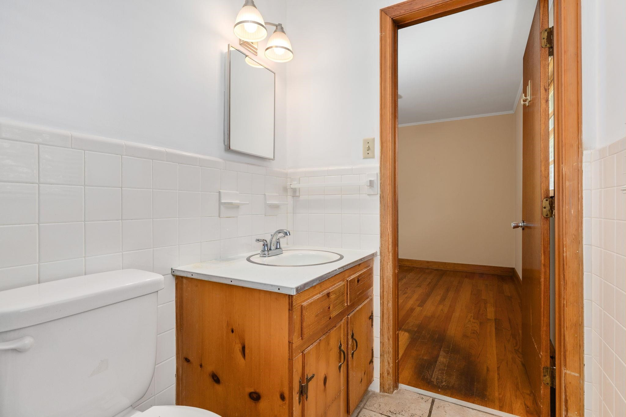 1309 Alpha Road Henderson, NC 27536 - Photo 21 of 26 a bathroom with a sink a toilet and mirror