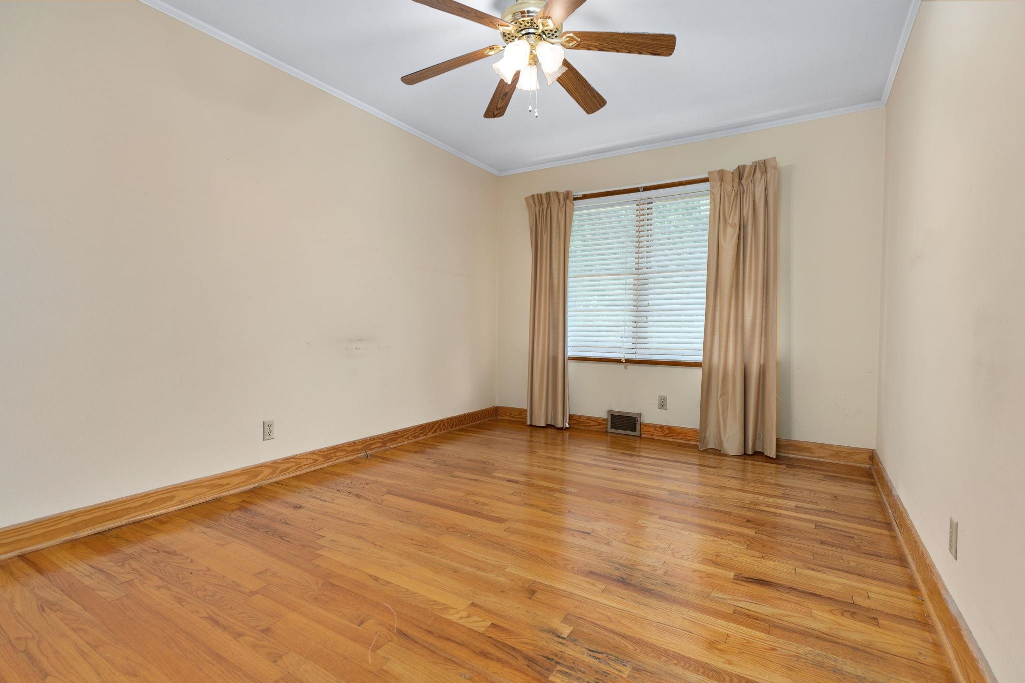 1309 Alpha Road Henderson, NC 27536 - Photo 24 of 26 an empty room with wooden floor fan and windows