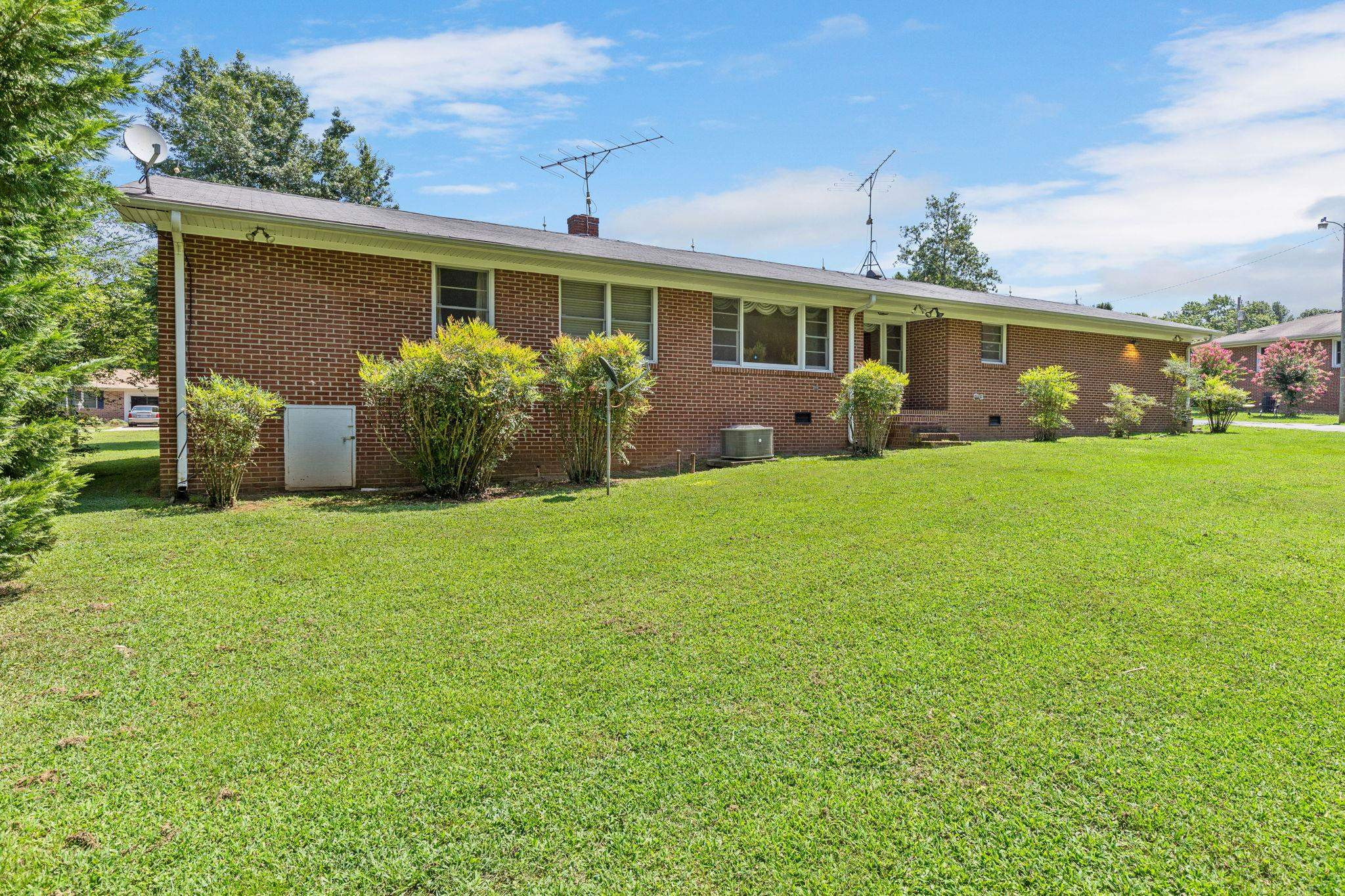 1309 Alpha Road Henderson, NC 27536 - Photo 4 of 26 a front view of a house with a yard and garage