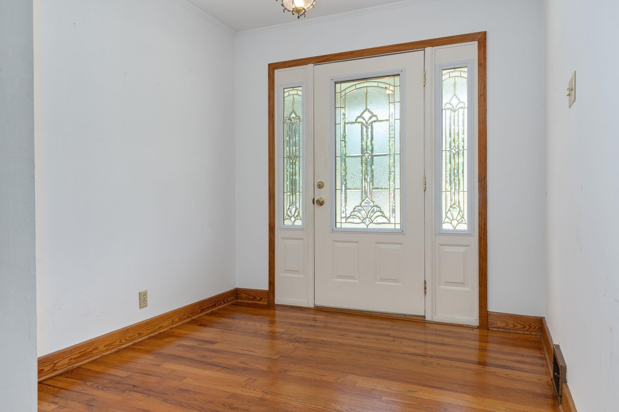 1309 Alpha Road Henderson, NC 27536 - Photo 7 of 26 an empty room with wooden floor and windows