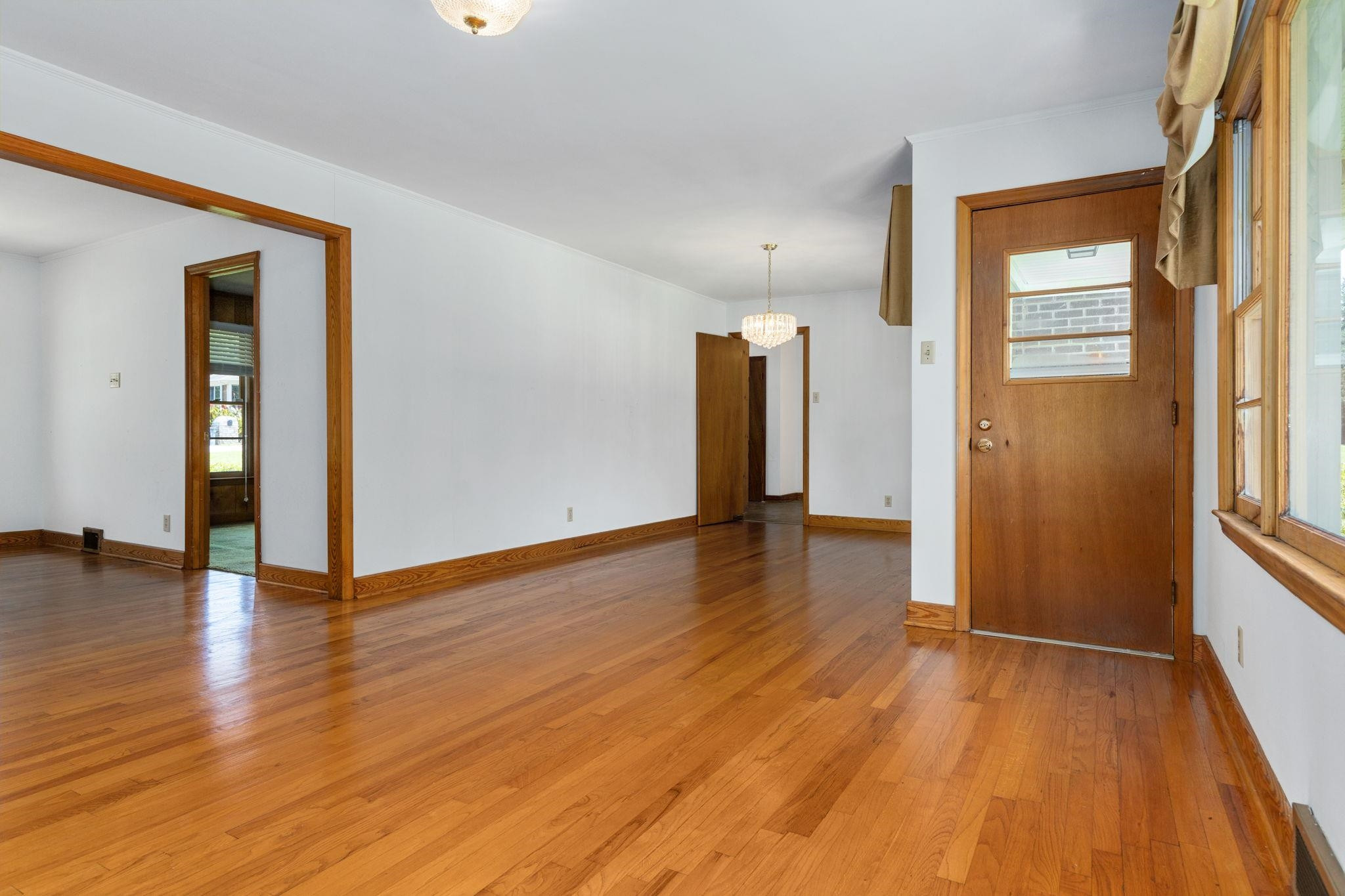 1309 Alpha Road Henderson, NC 27536 - Photo 10 of 26 a view of an empty room with window and wooden floor