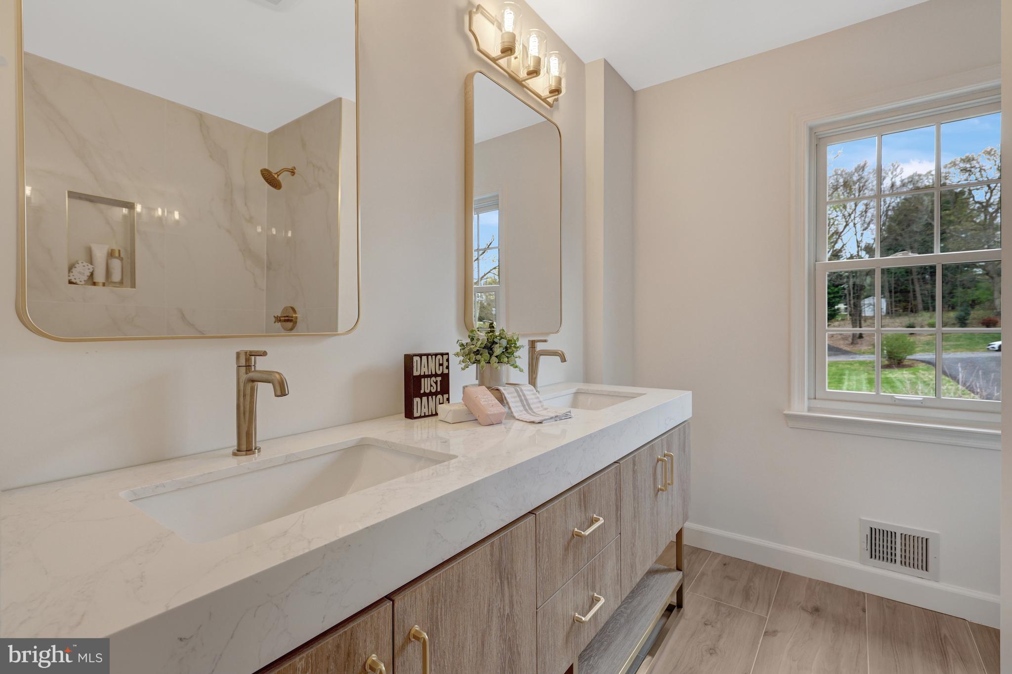 1215 Bishopsgate Way Reston, VA 20194 - Photo 18 of 41 a bathroom with a double vanity sink and a mirror