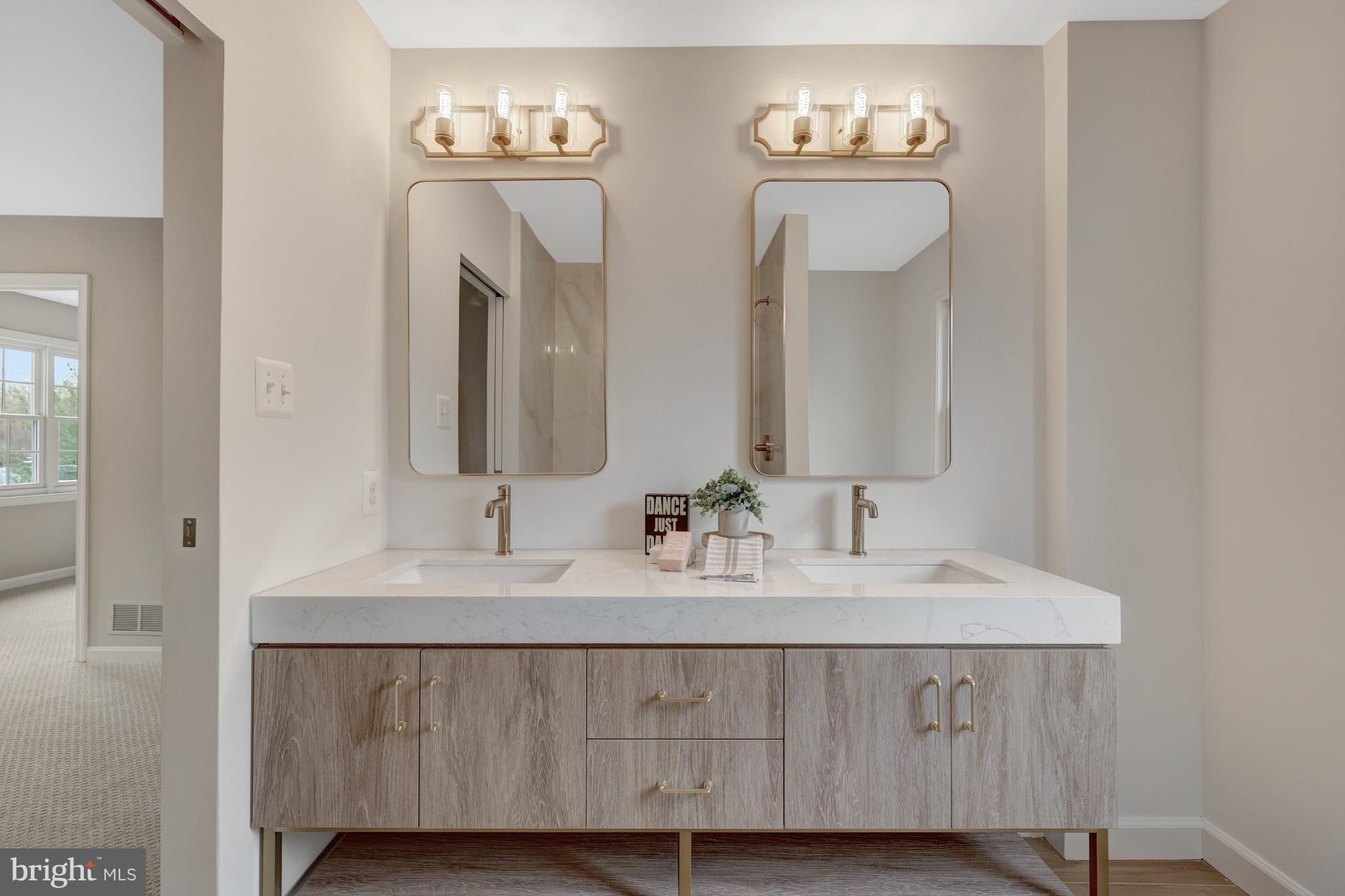 1215 Bishopsgate Way Reston, VA 20194 - Photo 19 of 41 a bathroom with double vanity sinks and a mirror