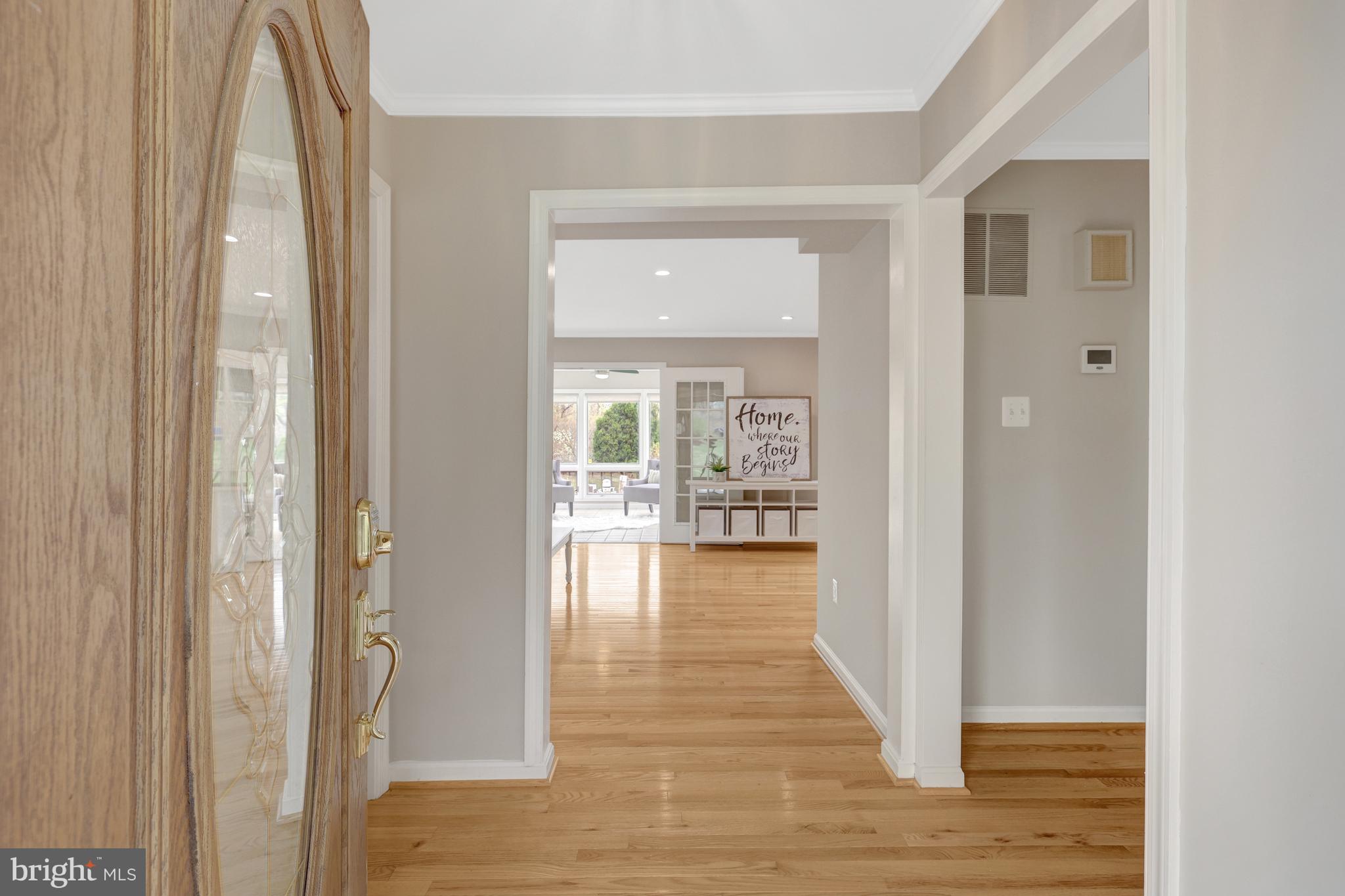 1215 Bishopsgate Way Reston, VA 20194 - Photo 2 of 41 a view of a hallway with wooden floor and a glass door