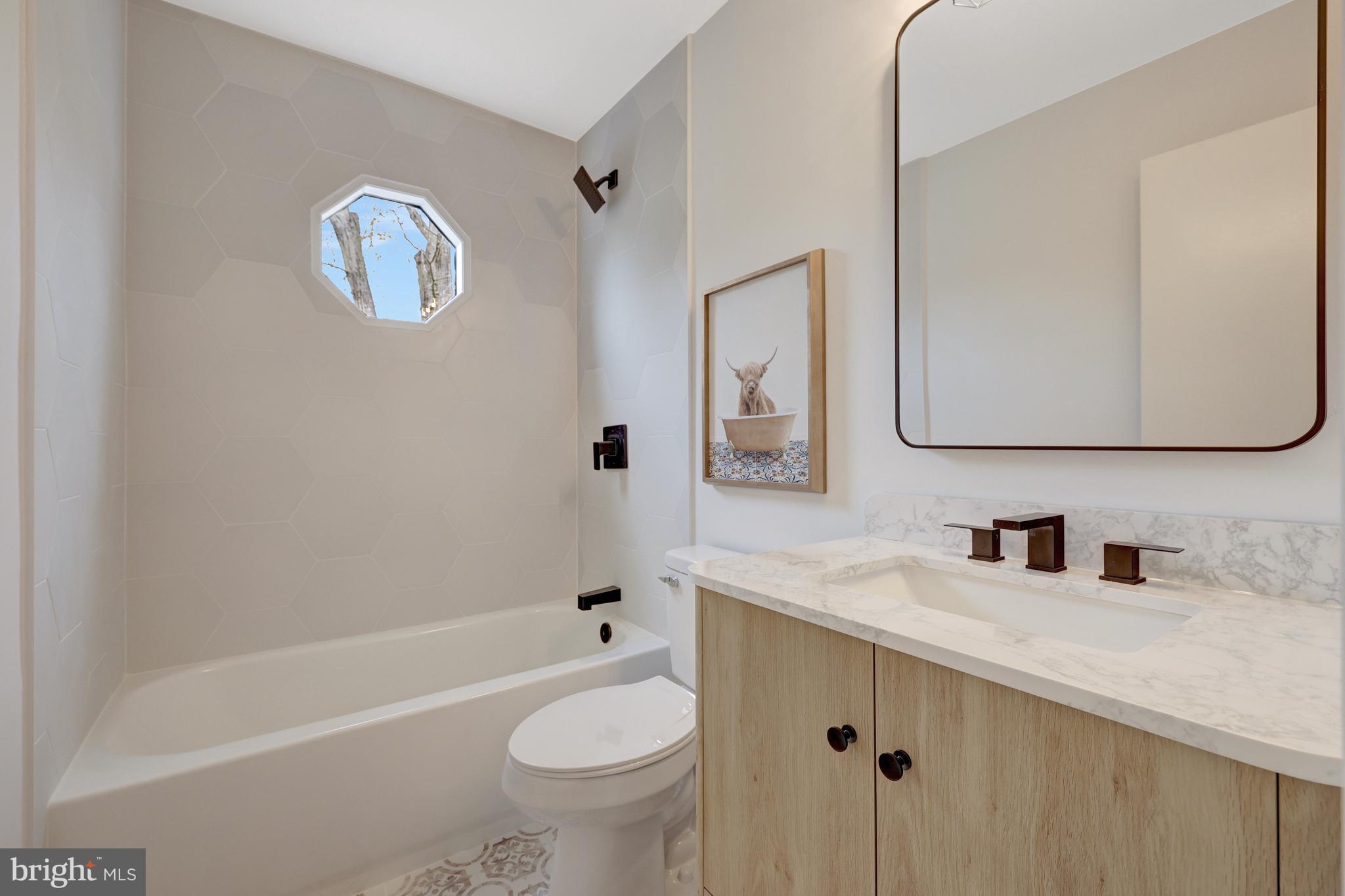 1215 Bishopsgate Way Reston, VA 20194 - Photo 24 of 41 a bathroom with a sink a toilet and shower