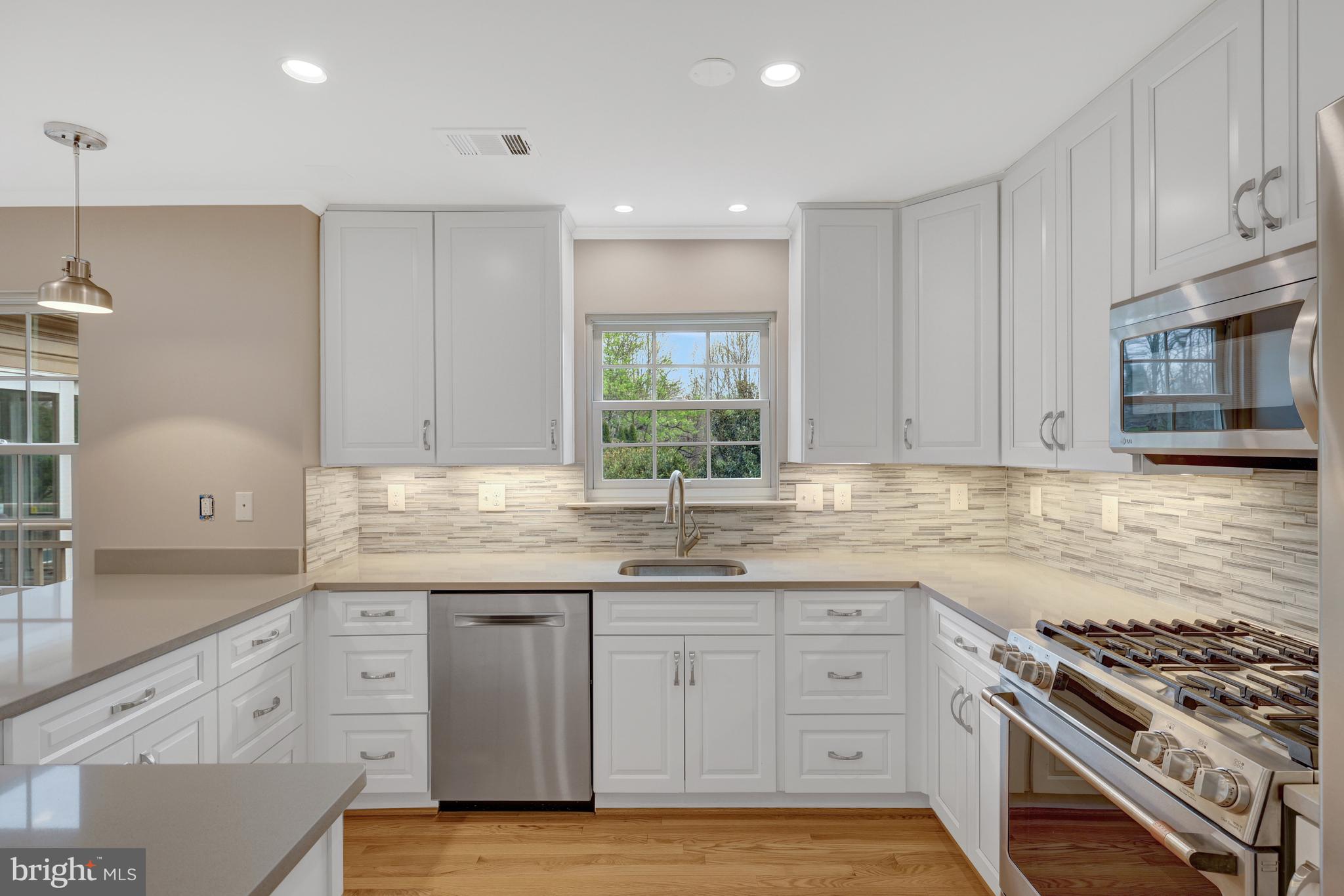 1215 Bishopsgate Way Reston, VA 20194 - Photo 8 of 41 a kitchen with granite countertop a sink stainless steel appliances and cabinets