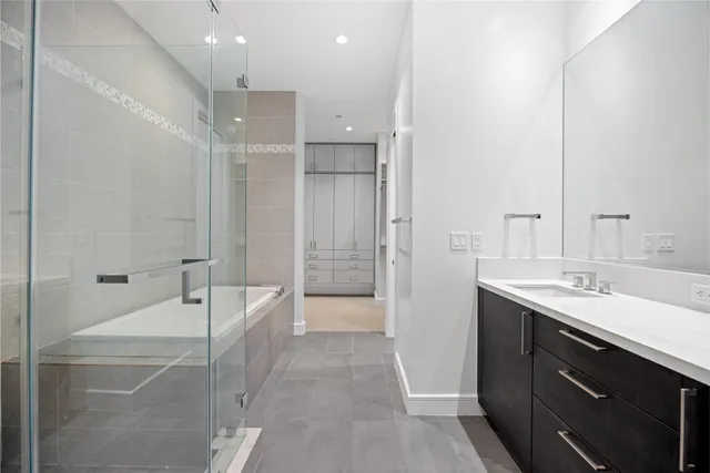 a picture of a living room with a rug floor to ceiling windows and a rug