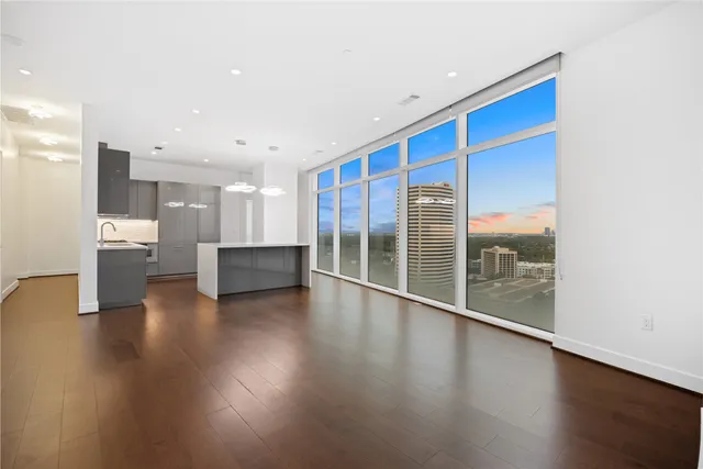 a view of room with window and wooden floor