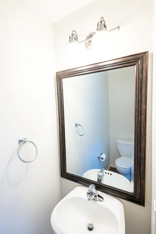 a bathroom with a tub sink and mirror