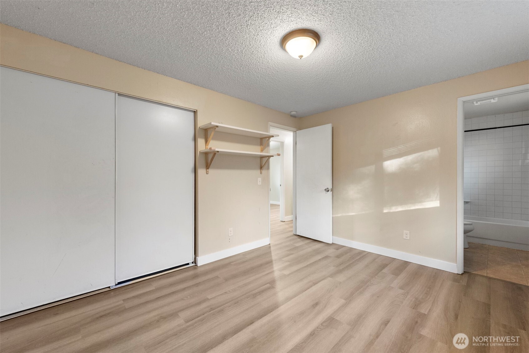 12727 Southeast 191st Place Renton, WA 98058 - Photo 11 of 23 an empty room with wooden floor and windows