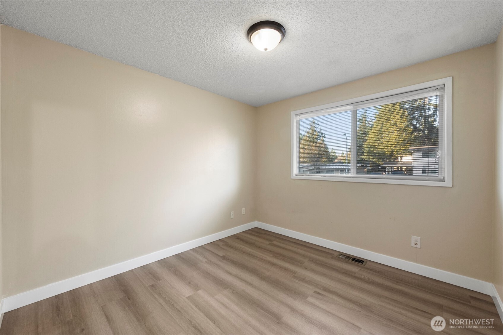 12727 Southeast 191st Place Renton, WA 98058 - Photo 12 of 23 a view of empty room with wooden floor