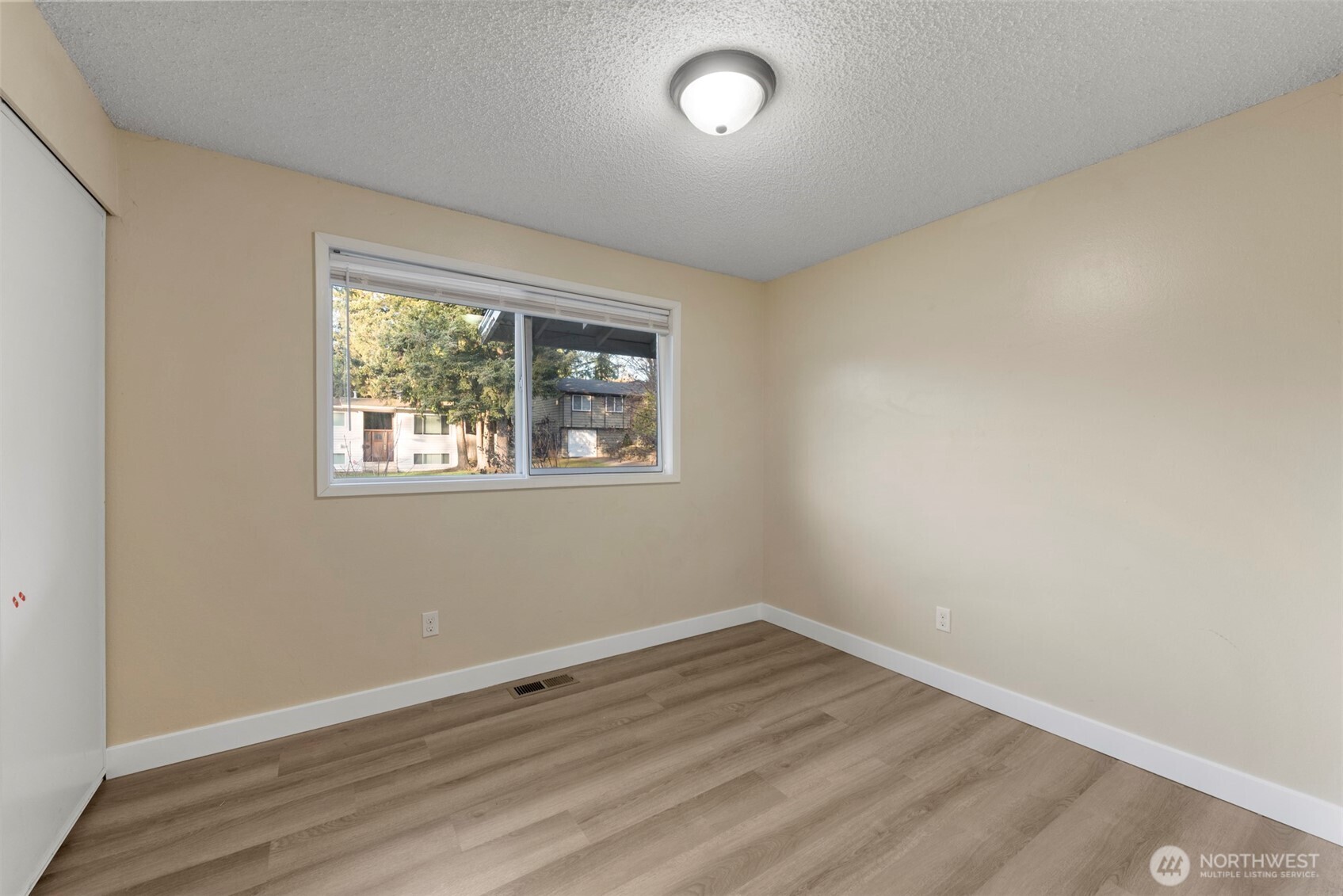 12727 Southeast 191st Place Renton, WA 98058 - Photo 14 of 23 an empty room with wooden floor and windows