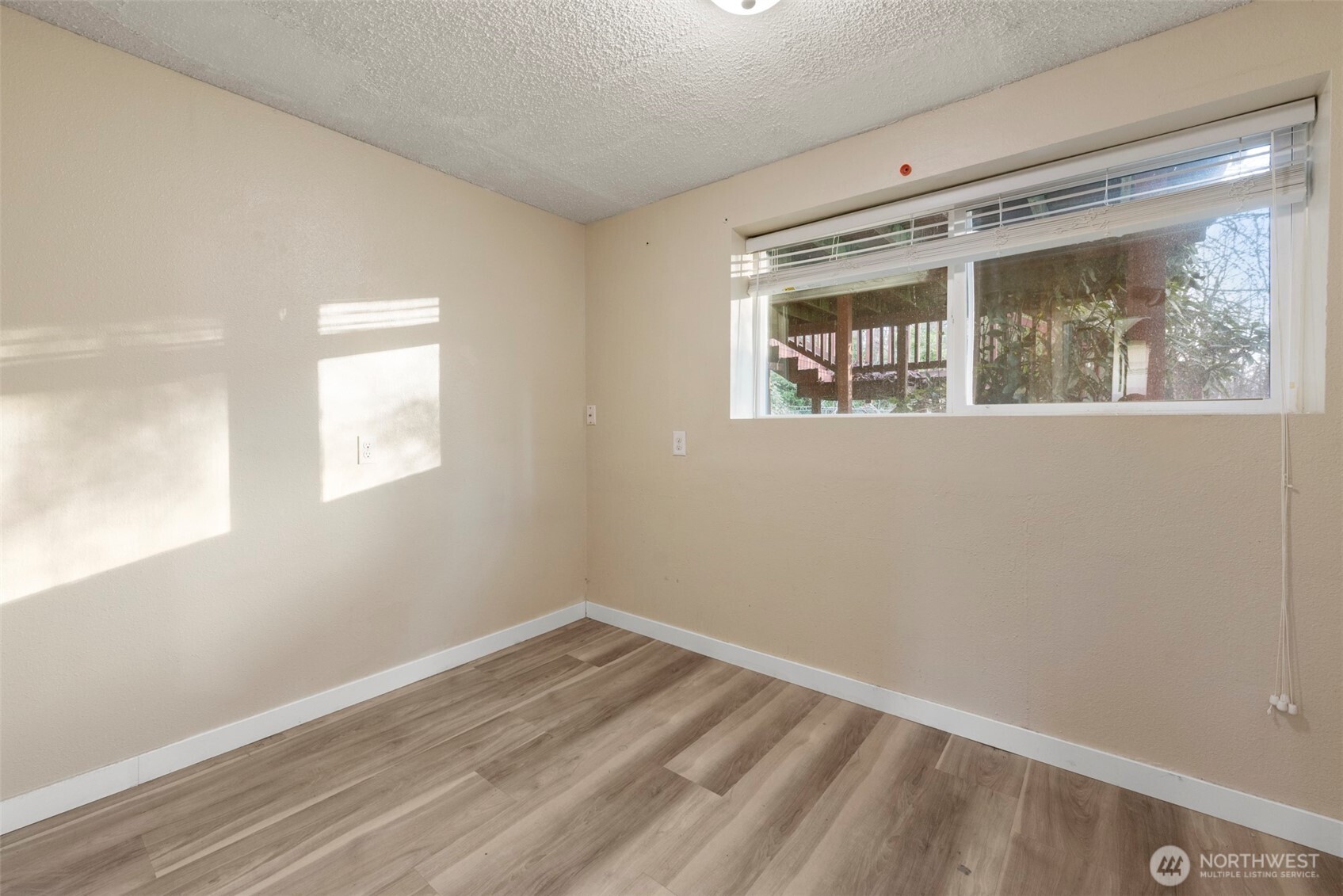 12727 Southeast 191st Place Renton, WA 98058 - Photo 16 of 23 a view of empty room with wooden floor and fan