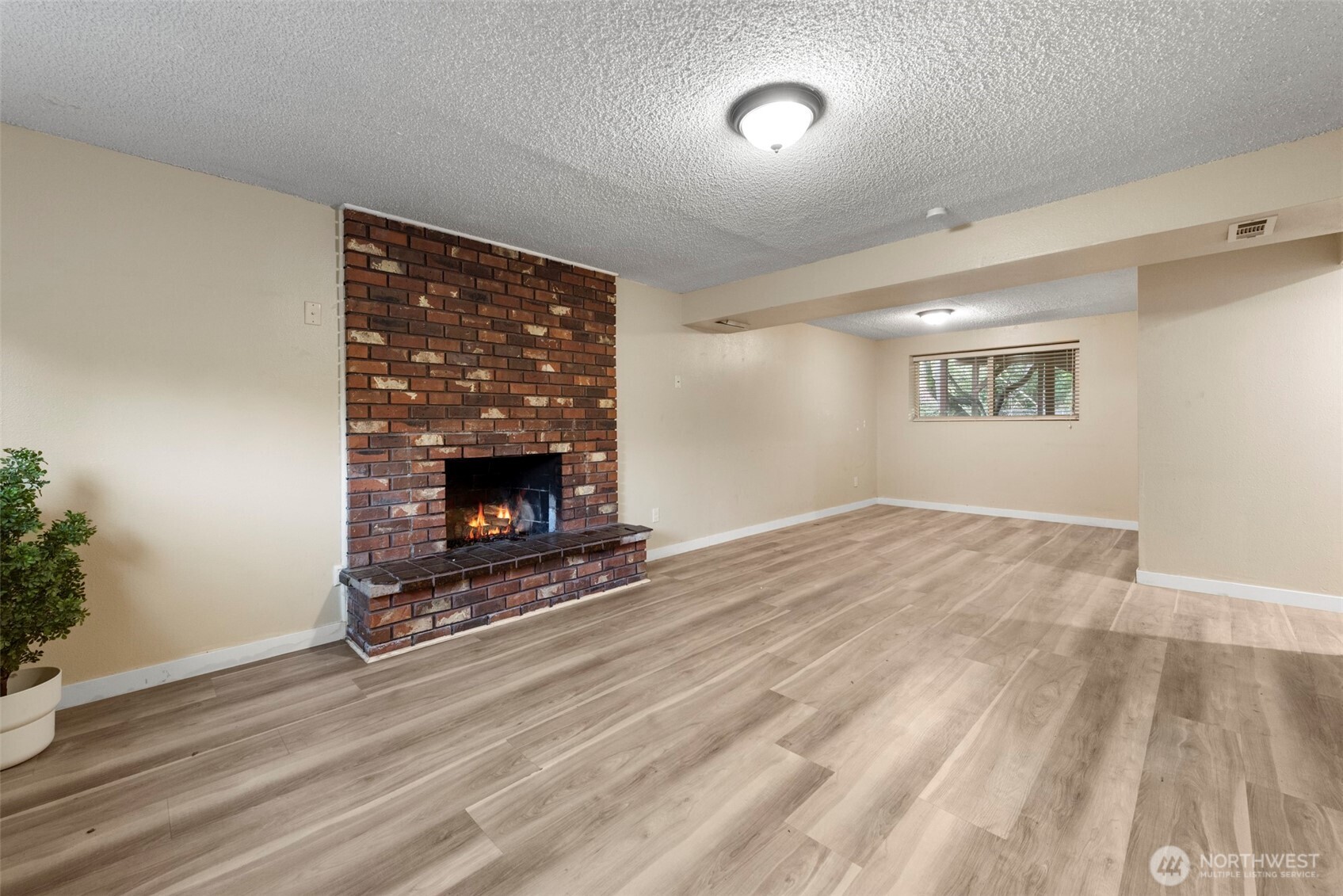 12727 Southeast 191st Place Renton, WA 98058 - Photo 18 of 23 wooden floor fireplace and natural light in room