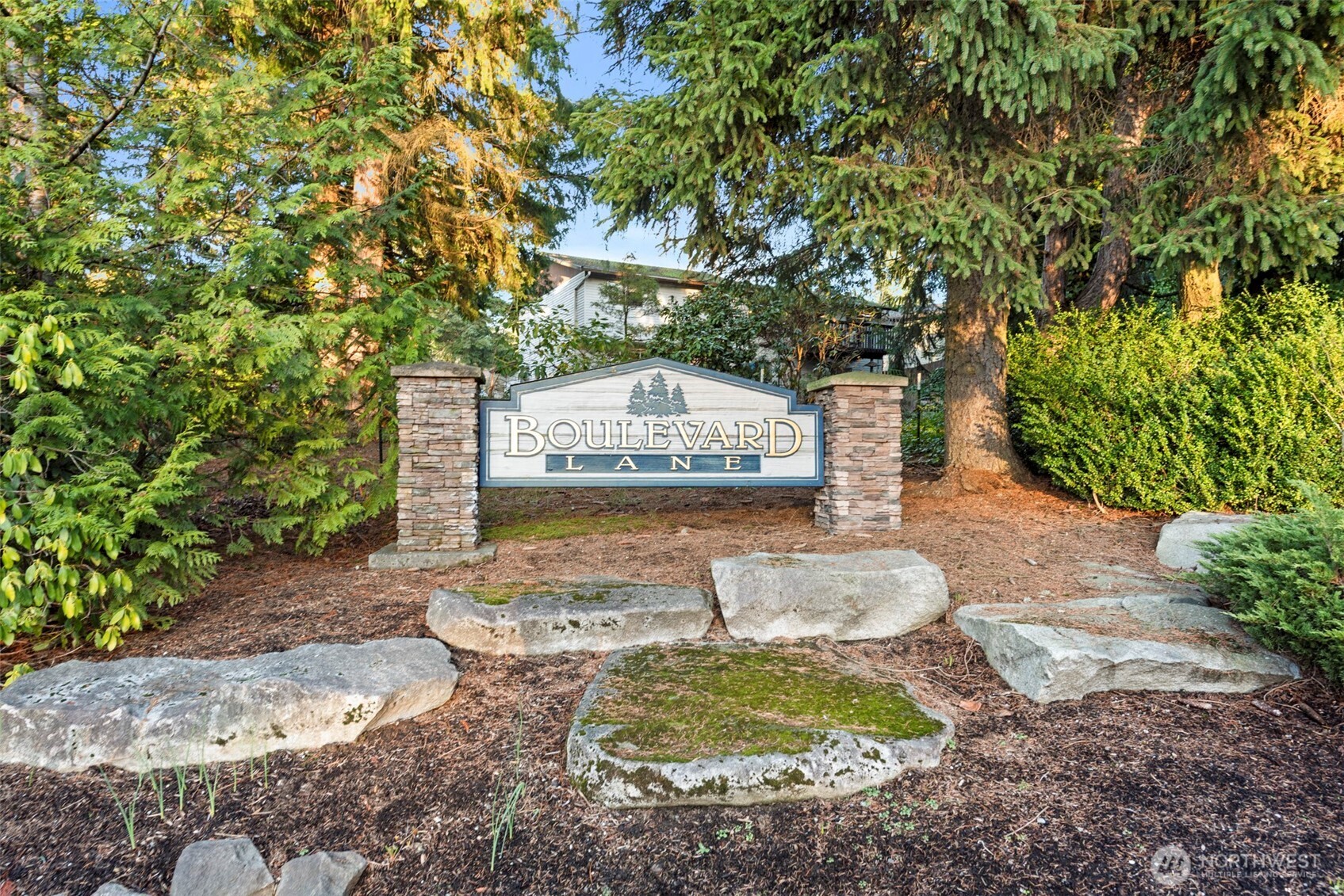 12727 Southeast 191st Place Renton, WA 98058 - Photo 23 of 23 a view of a backyard with fountain plants and large trees