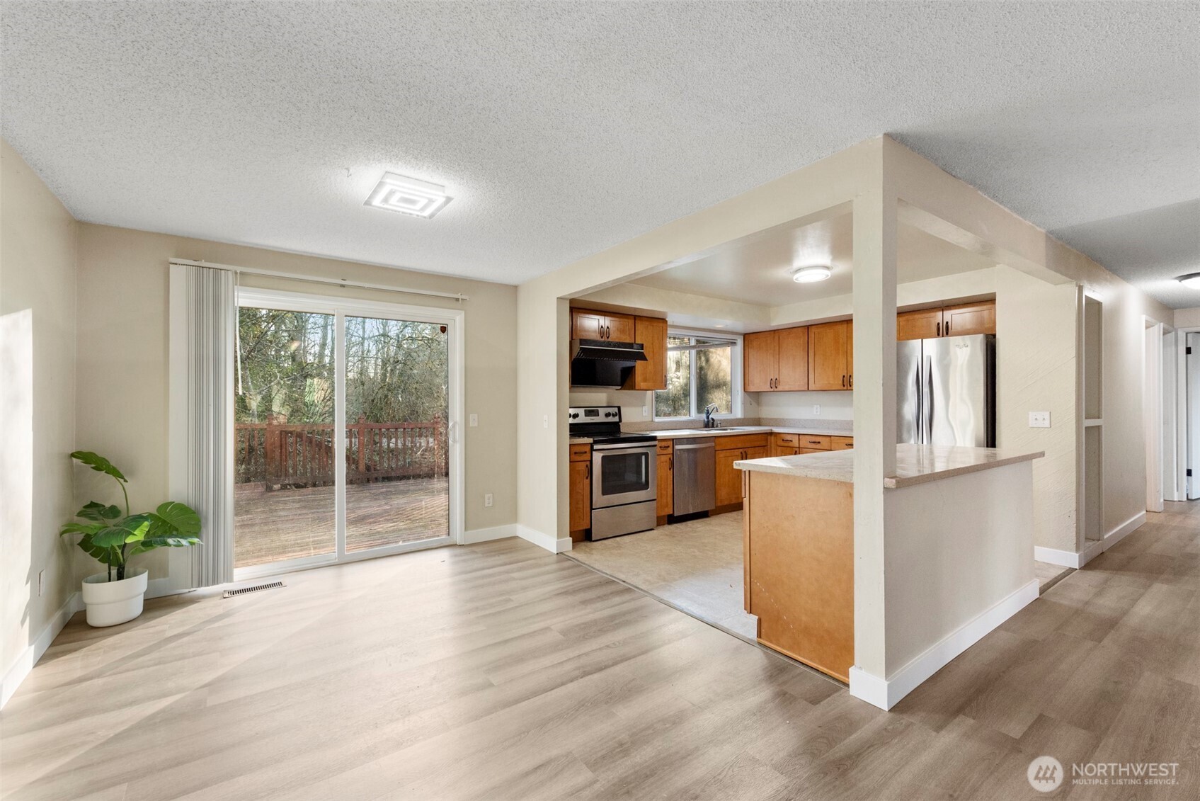 12727 Southeast 191st Place Renton, WA 98058 - Photo 7 of 23 a kitchen with stainless steel appliances a refrigerator and a stove top oven