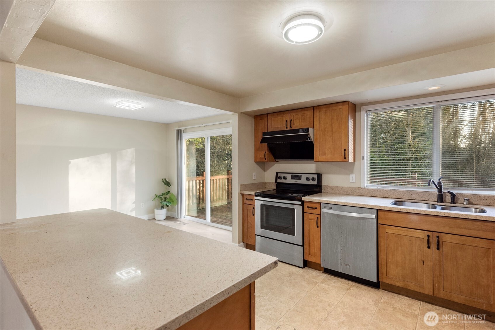 12727 Southeast 191st Place Renton, WA 98058 - Photo 9 of 23 a kitchen with stainless steel appliances a stove sink microwave and refrigerator
