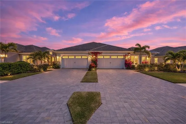 a front view of a house with a yard and mountain view