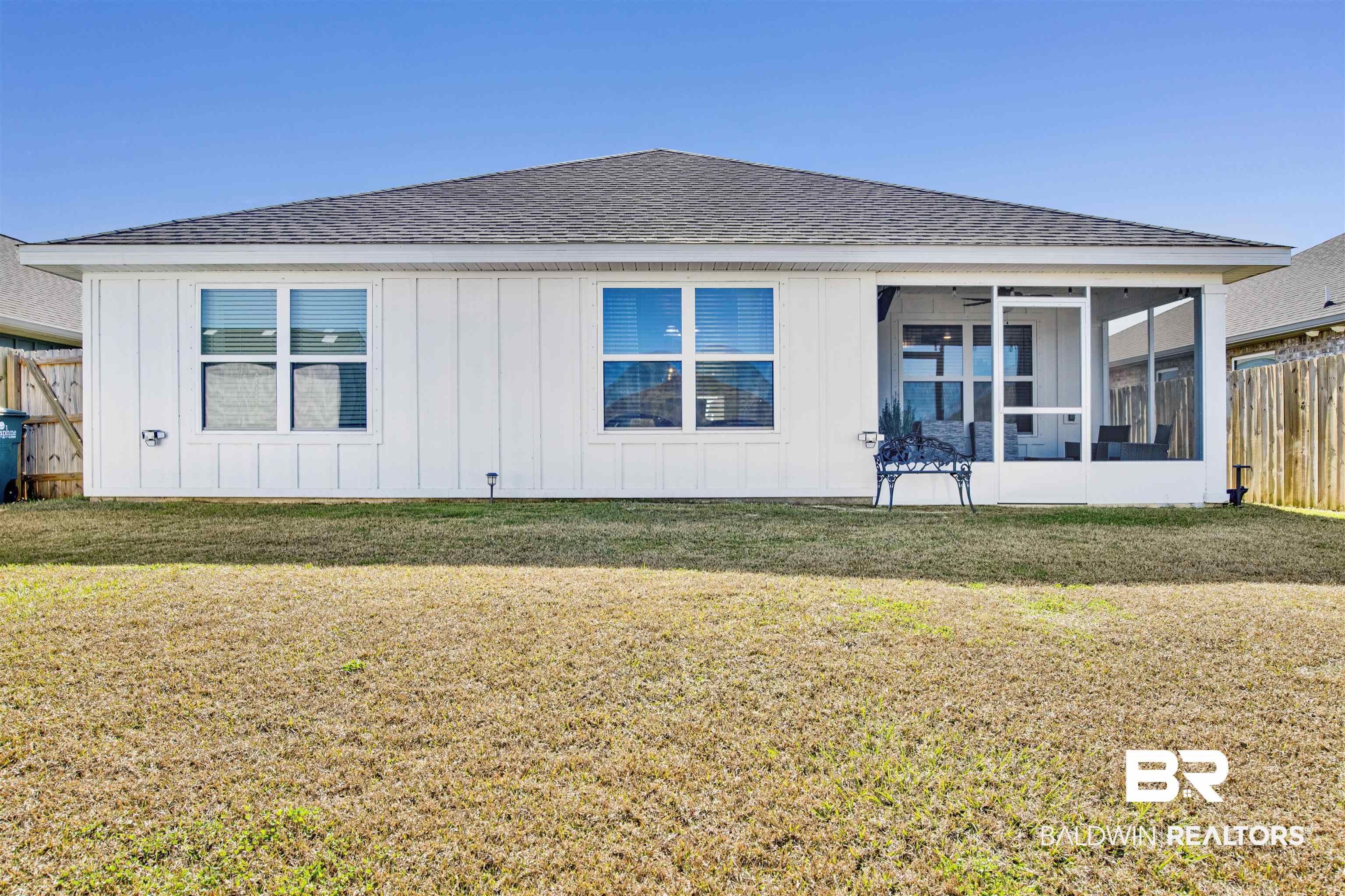 8102 Irwin Loop Daphne, AL 36526 - Photo 28 of 30 Back of property with a sunroom and a lawn