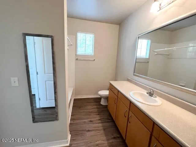 a bathroom with a sink a toilet and a mirror