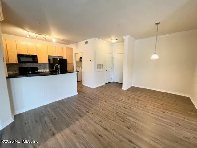 a view of a kitchen with a sink and a refrigerator