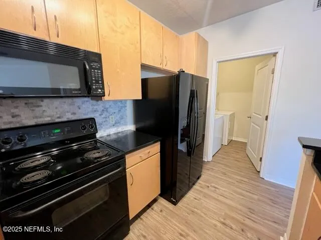 a kitchen with stainless steel appliances a stove a microwave and a refrigerator