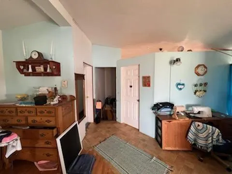 a bedroom with furniture and a window