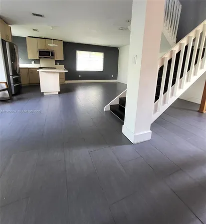a view of kitchen with sink and cabinets