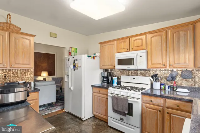 a kitchen with a refrigerator stove and sink