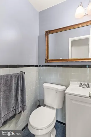 a white toilet sitting next to a bathroom sink