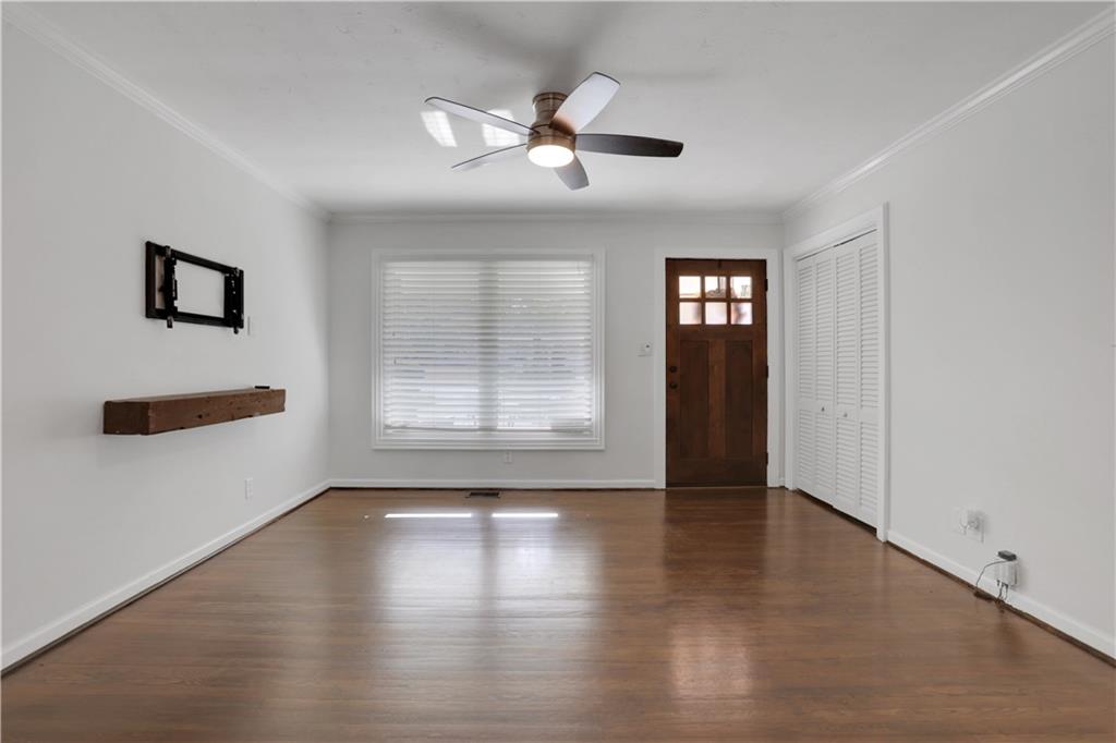 3038 Flamingo Drive Decatur, GA 30033 - Photo 3 of 39 a view of an empty room with wooden floor and a window