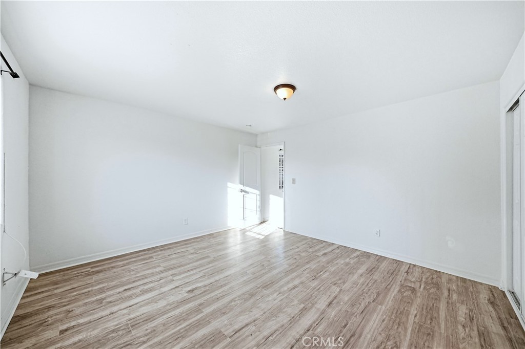 10929 Compton Avenue Los Angeles, CA 90059 - Photo 13 of 29 a view of an empty room with wooden floor