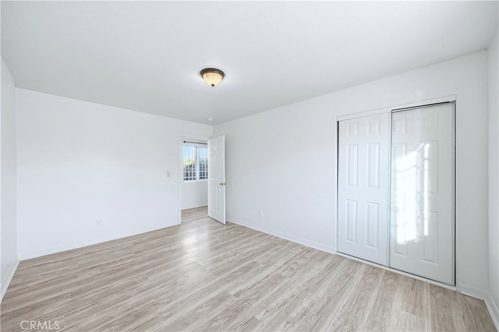 10929 Compton Avenue Los Angeles, CA 90059 - Photo 14 of 29 an empty room with wooden floor and windows