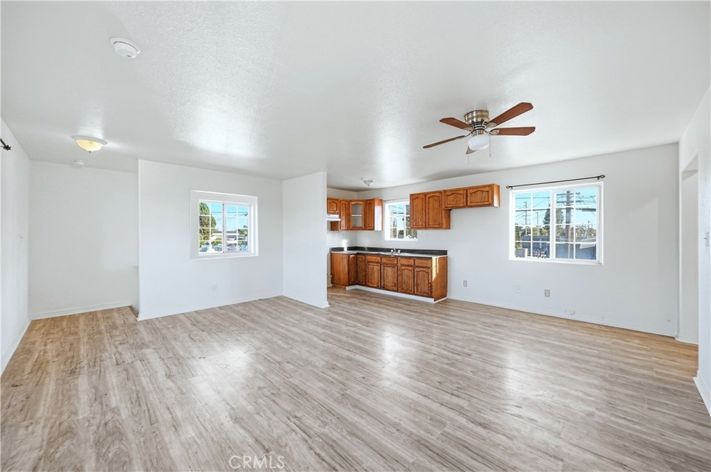 10929 Compton Avenue Los Angeles, CA 90059 - Photo 17 of 29 an empty room with windows and ceiling fan