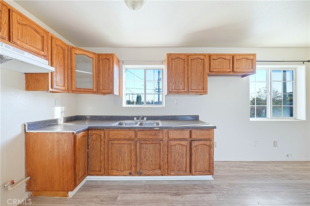 10929 Compton Avenue Los Angeles, CA 90059 - Photo 20 of 29 a kitchen with a sink cabinets and window