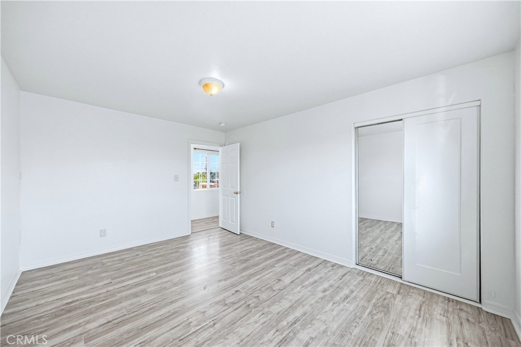 10929 Compton Avenue Los Angeles, CA 90059 - Photo 23 of 29 an empty room with wooden floor and windows
