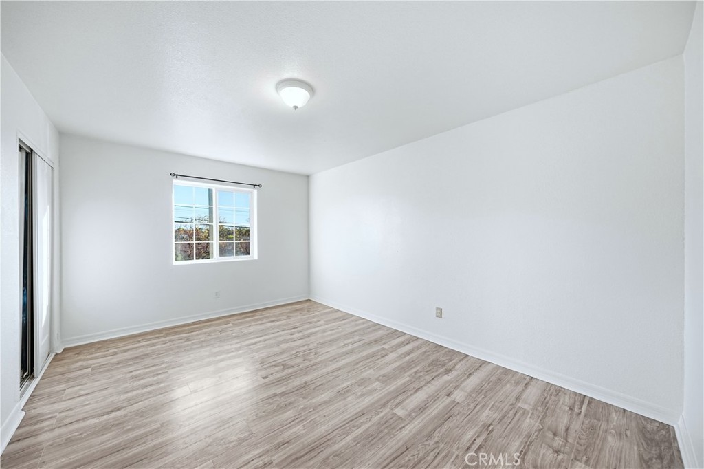 10929 Compton Avenue Los Angeles, CA 90059 - Photo 24 of 29 an empty room with wooden floor and windows
