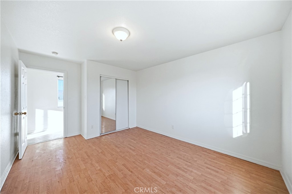 10929 Compton Avenue Los Angeles, CA 90059 - Photo 28 of 29 a bedroom with a bed and a window