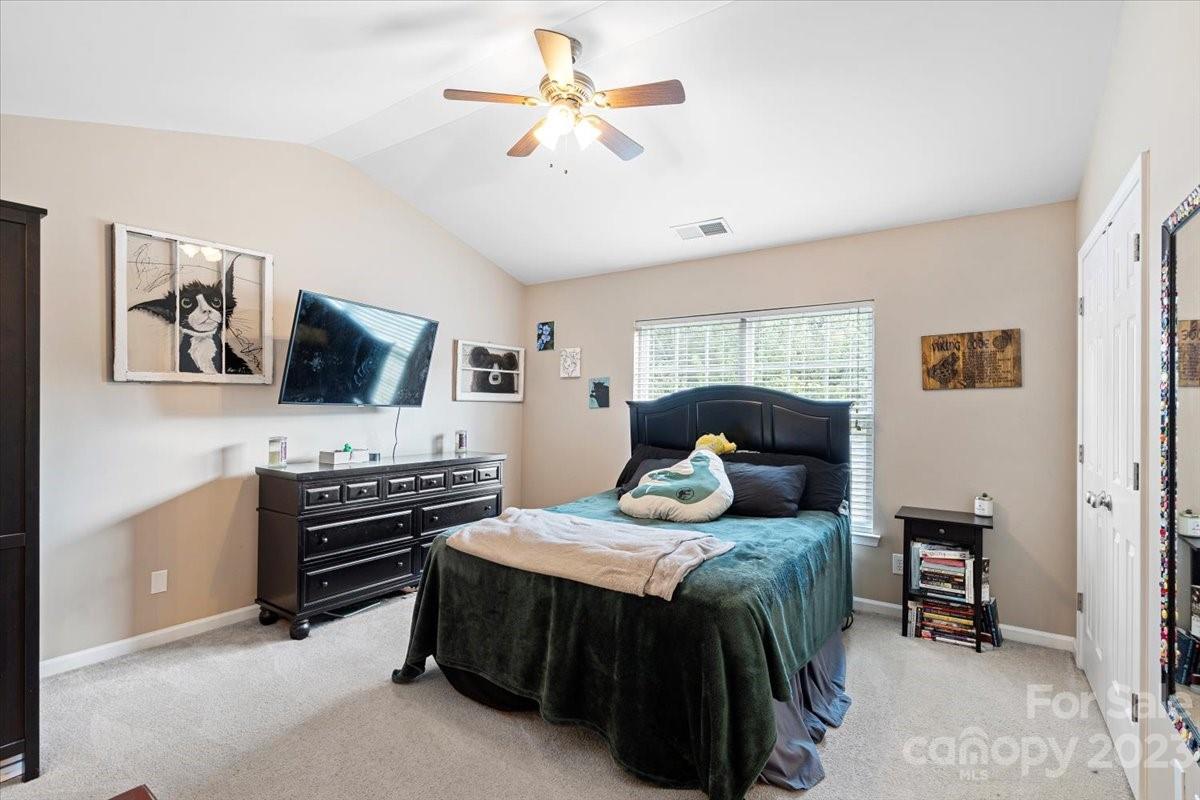 3006 Summerfield Ridge Lane Matthews, NC 28105 - Photo 11 of 17 a bedroom with a bed and a flat screen tv