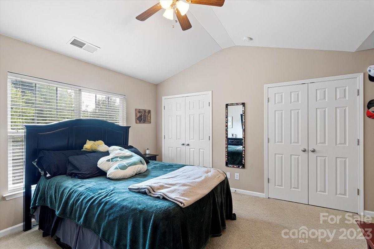 3006 Summerfield Ridge Lane Matthews, NC 28105 - Photo 12 of 17 a bedroom with a bed and a chandelier
