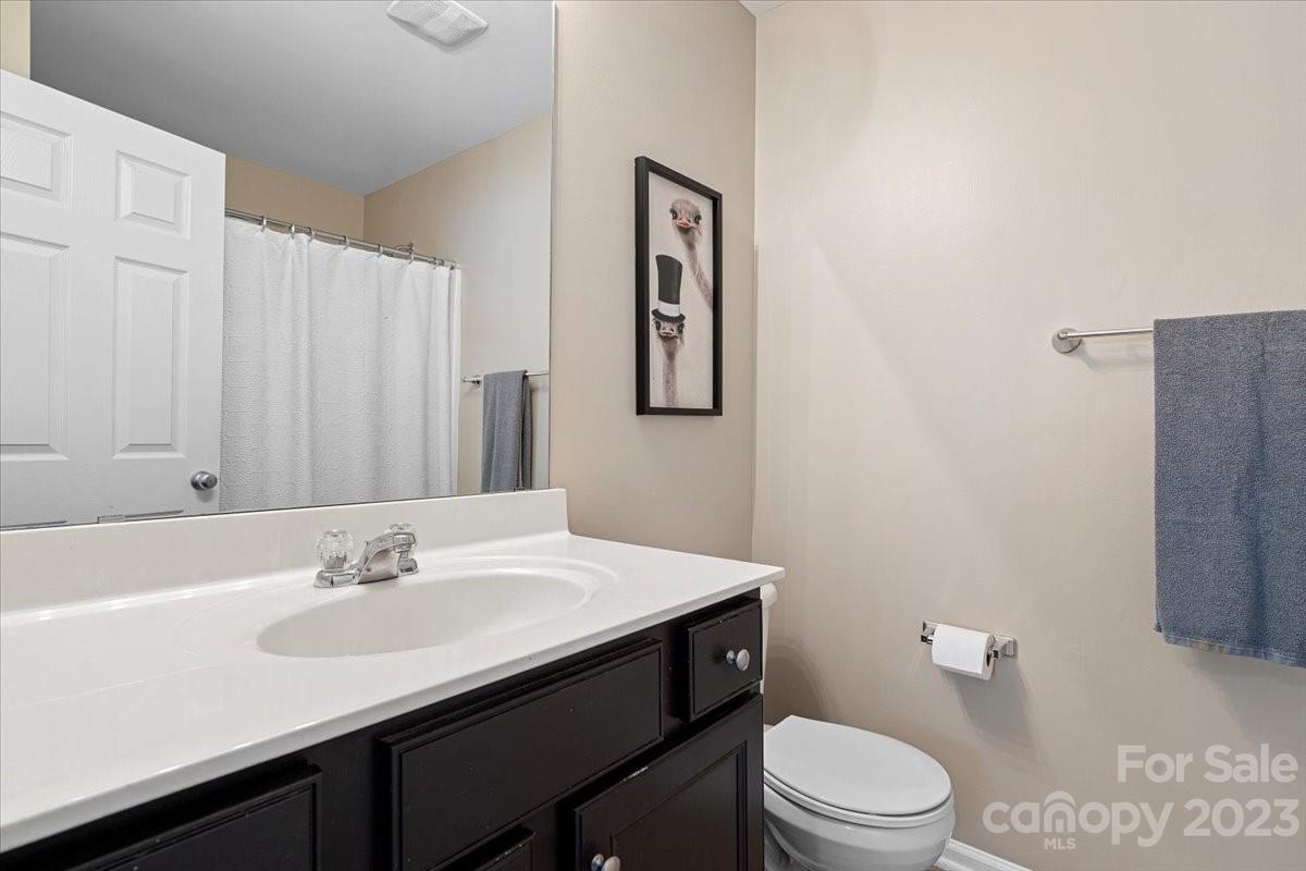 3006 Summerfield Ridge Lane Matthews, NC 28105 - Photo 13 of 17 a bathroom with a sink a toilet and mirror