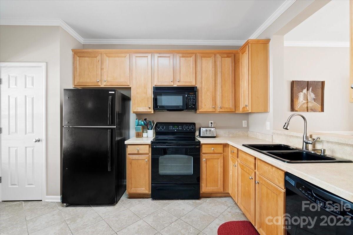 3006 Summerfield Ridge Lane Matthews, NC 28105 - Photo 4 of 17 a kitchen with a refrigerator and a stove